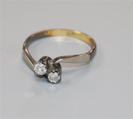 An 18ct gold and diamond two stone crossover ring, size M.